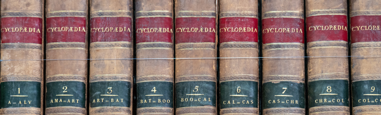 a close up of old encyclopedias in a row