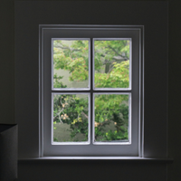a window with four panes looks out on the greenery outside