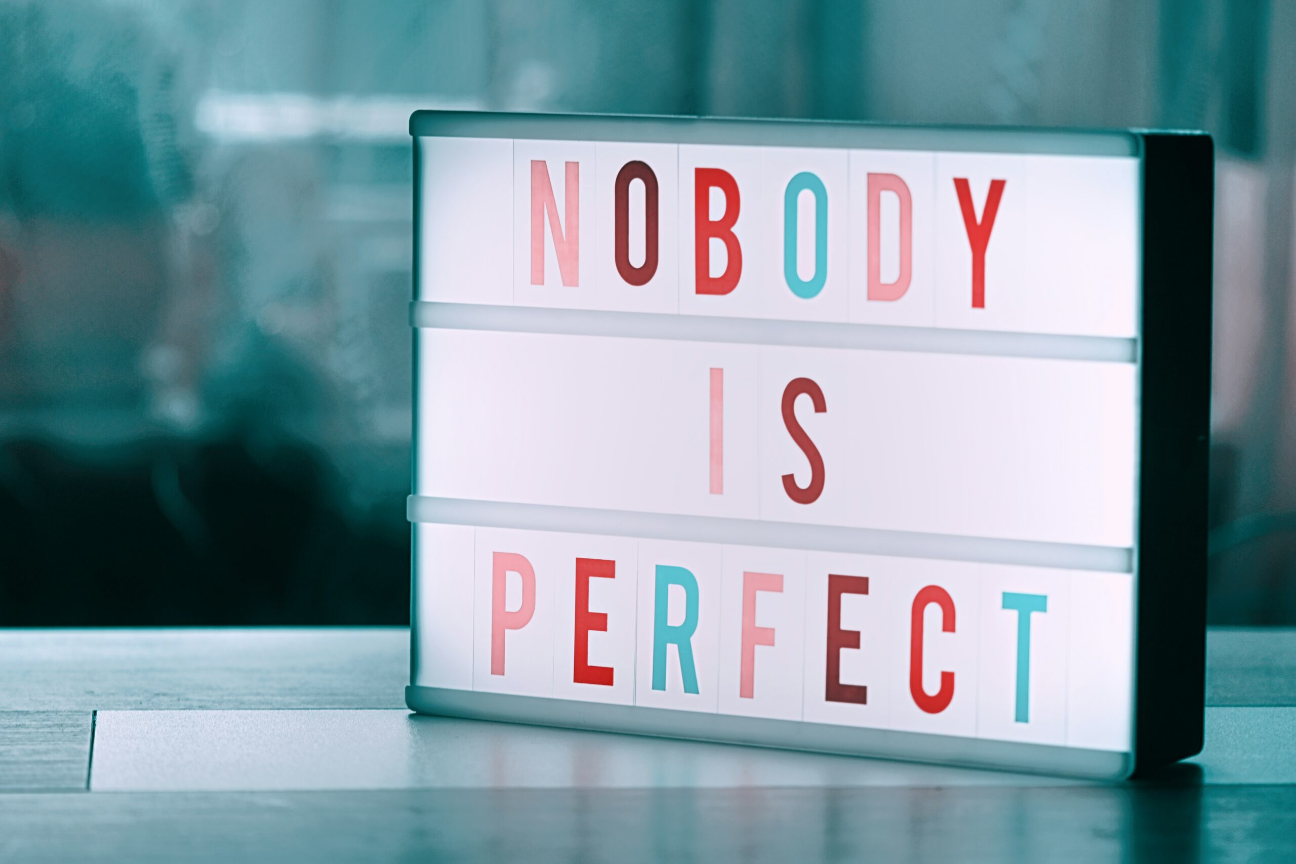 a light box reads nobody is perfect